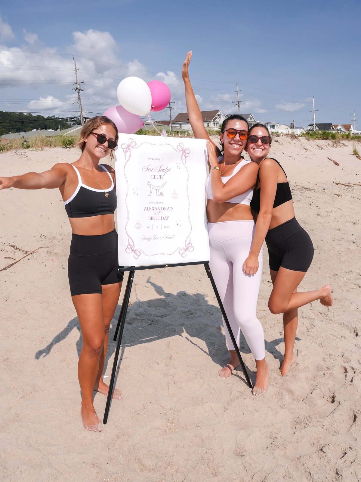 Three women celebrating a birthday beach Pilates party
